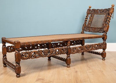 Lot 136 - A Carolean style carved oak daybed, with...