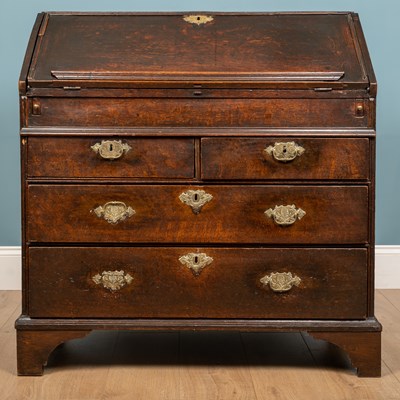 Lot 135 - A writing bureau, oak with brass plated key...