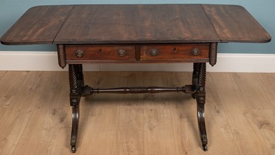 Lot 341 - A Regency mahogany sofa table with walnut...