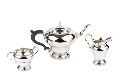 Lot 689 - A silver three piece tea service, of shaped...