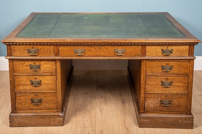 Lot 269 - An oak pedestal desk with green leather inset...