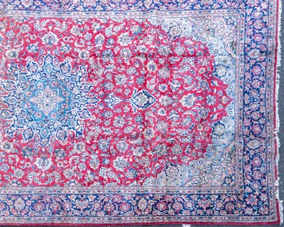 Lot 332 - A large Oriental red ground rug with floral...