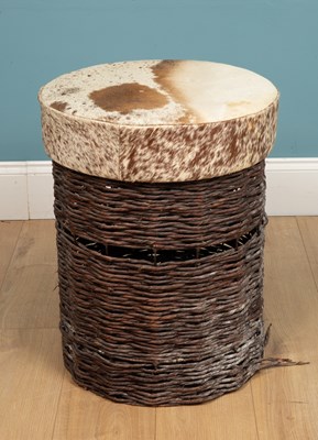 Lot 343 - A cow hide upholstered stool, with a rattan...