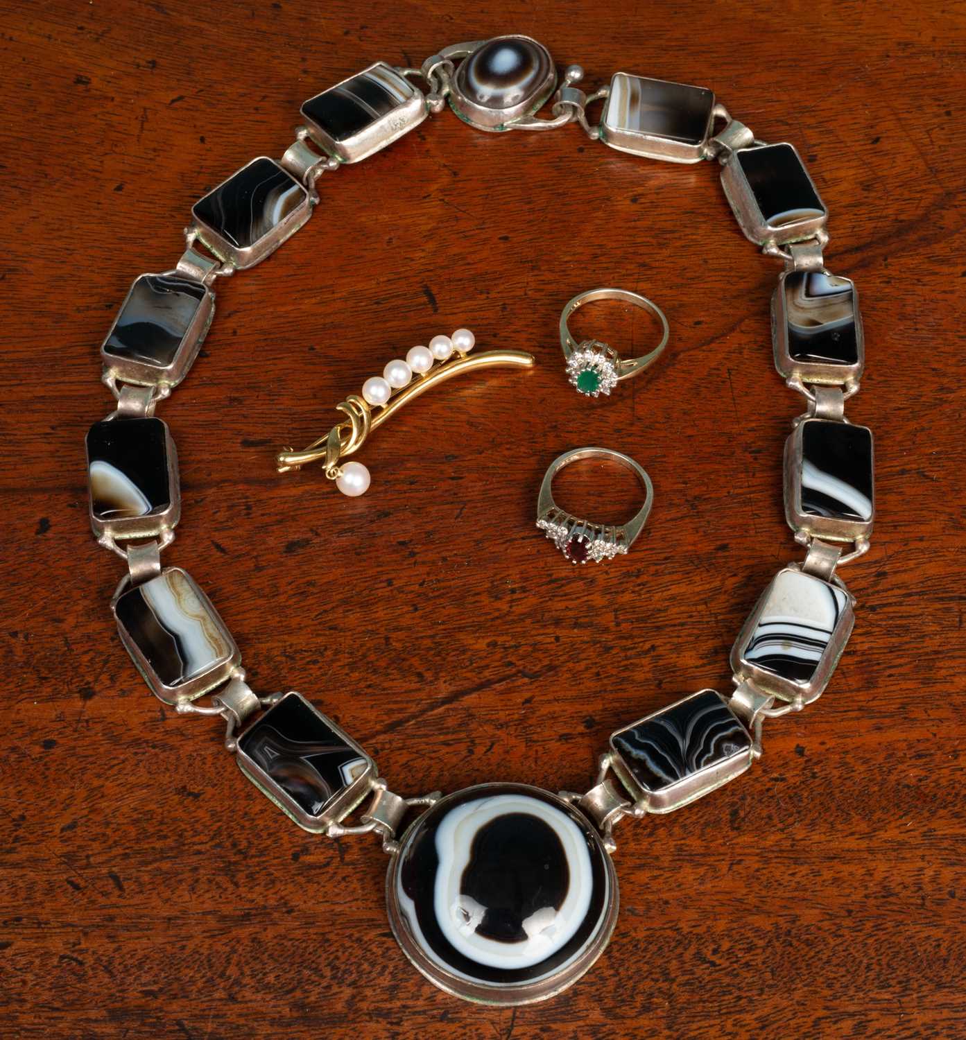 Lot 16 - Two silver rings; a hardstone set necklace; and with a brooch