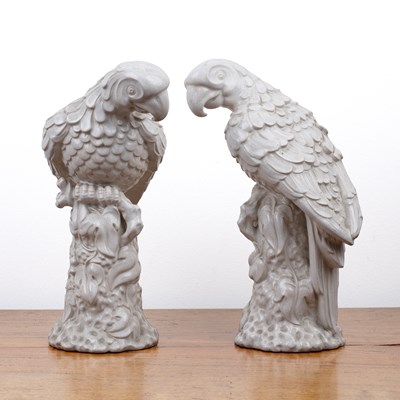 Lot 197 - Pair of white glazed models of parrots...