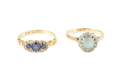 Lot 274 - A sapphire and diamond half hoop ring, centred...