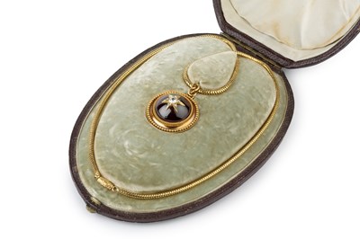 Lot 26 - A Victorian garnet and diamond locket pendant...