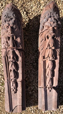 Lot 1174 - A pair of carved red sandstone architectural scrolling corbels