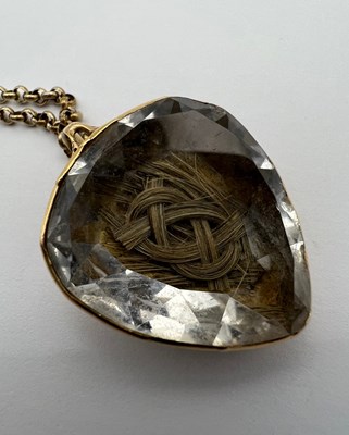 Lot 21 - A hairwork memorial pendant on chain, the...