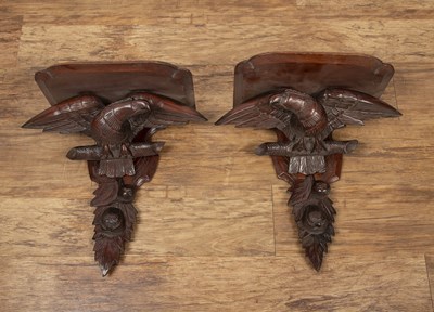 Lot 34 - Pair of carved eagle wall brackets stained...