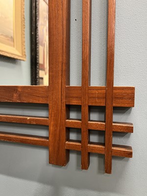 Lot 408 - A mid-century Italian, walnut wall mirror attributed to Ettore Sottsass