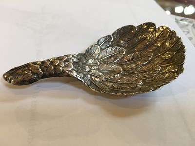 Lot 537 - A George III silver eagle's wing caddy spoon,...