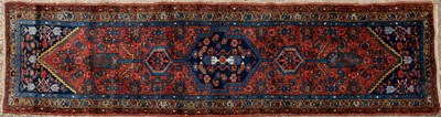 Lot 1052 - A small Oriental red ground runner