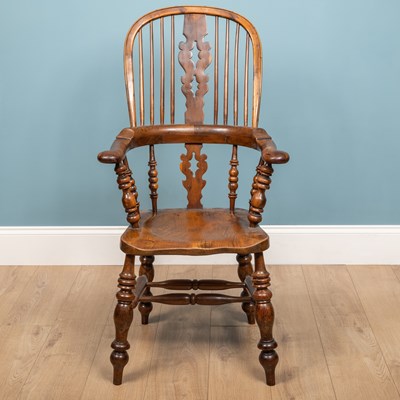 Lot 329 - A 19th century yew and elm Windsor armchair