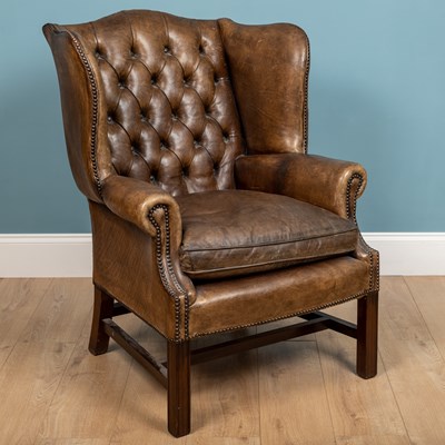 Lot 317 - A George III-style dark green leather upholstered armchair