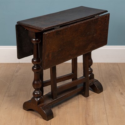 Lot 475 - An antique oak small sized drop leaf occasional table