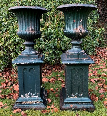 Lot 1131 - A pair of antique green painted cast iron campana urns