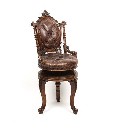 Lot 129 - A Victorian walnut music stool with carved...