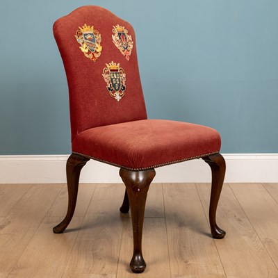 Lot 232 - A red upholstered chair with three crest...