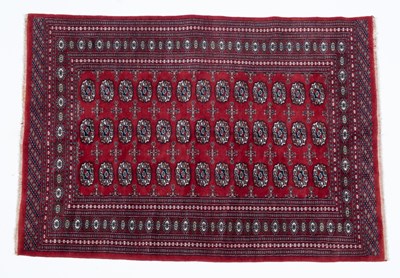 Lot 1056 - A red ground Baluch rug