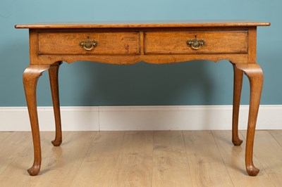 Lot 280 - A desk table, oak, with two drawers and brass...