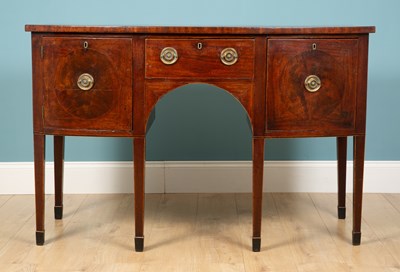 Lot 283 - A curved mahogany sideboard, with two cabinets...