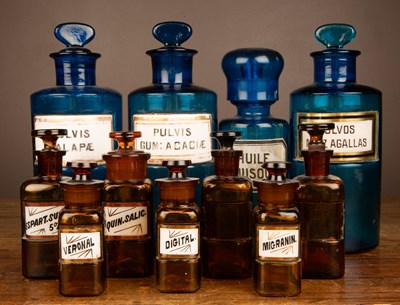 Lot 1009 - A collection of blue and brown glass chemist's jars