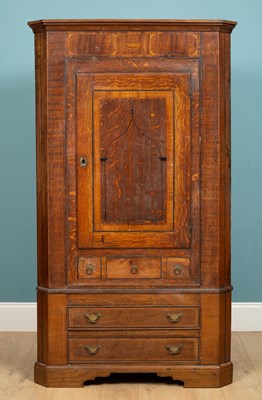 Lot 306 - A George III oak floor standing corner...