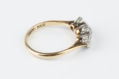 Lot 46 - A diamond three stone ring, the graduated...