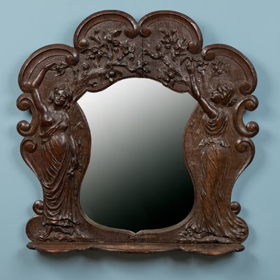 Lot 326 - A carved oak wall mirror with a ledge