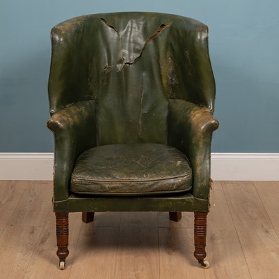 Lot 528 - A 19th century green leather barrelback armchair