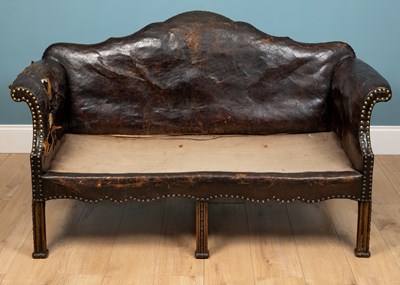 Lot 278 - A brown leather camelback sofa