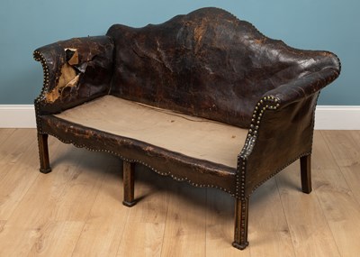 Lot 278 - A brown leather camelback sofa