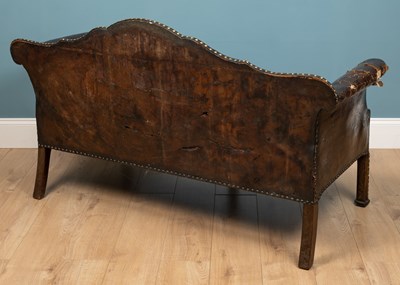 Lot 278 - A brown leather camelback sofa