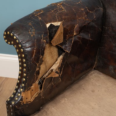 Lot 278 - A brown leather camelback sofa