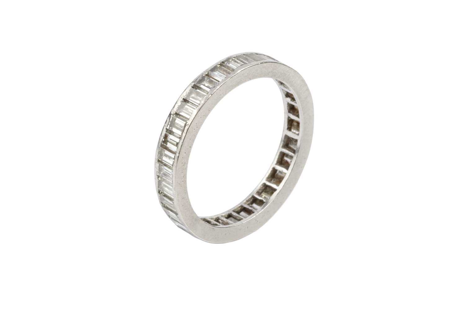 Lot 104 - A diamond full hoop eternity ring, channel set...