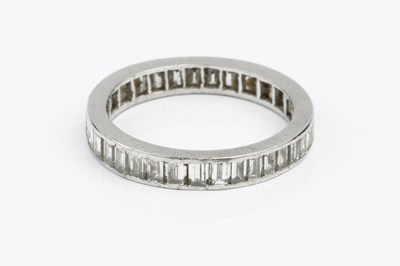 Lot 104 - A diamond full hoop eternity ring, channel set...