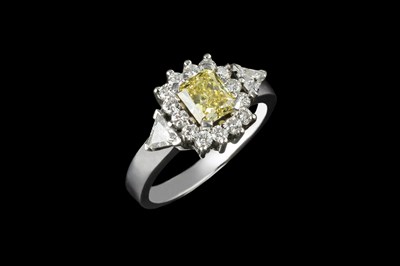 Lot 144 - A diamond cluster ring, centred with a radiant-...