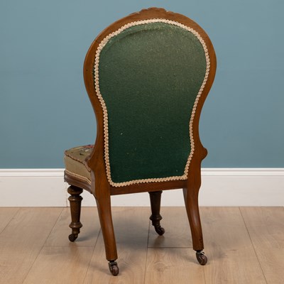Lot 254 - A Victorian walnut nursing chair