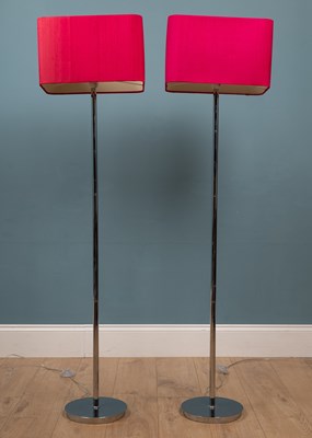 Lot 537 - A pair of tall modern floor lamps with chrome stands and rectangular fuschia lampshades