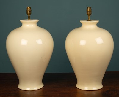 Lot 578 - A pair of cream pottery table lamps