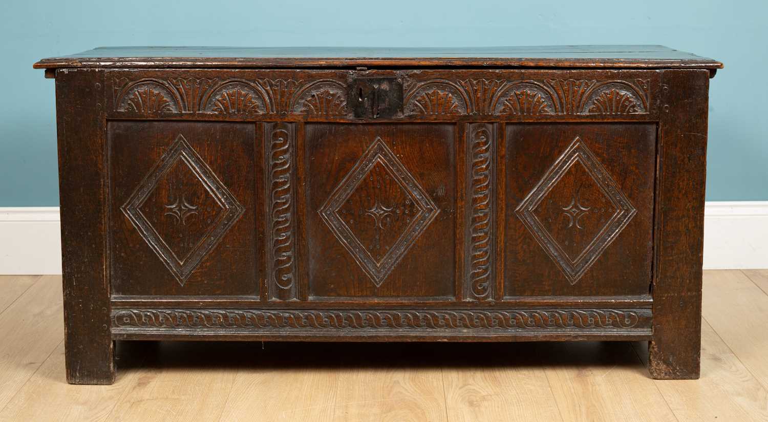 Lot 324 - An antique coffer with a triple panel front