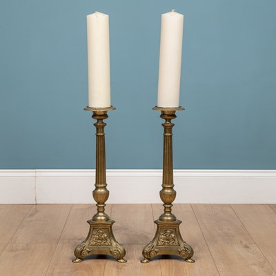 Lot 432 - A pair of large brass candlesticks