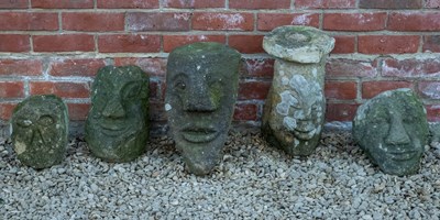 Lot 1164 - Five roughly carved stone heads