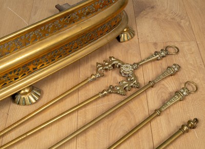 Lot 488 - A 19th century pierced brass fender; together with a set of three brass fire irons and a brass extending toasting fork