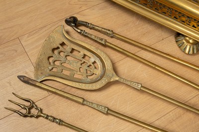 Lot 488 - A 19th century pierced brass fender; together with a set of three brass fire irons and a brass extending toasting fork