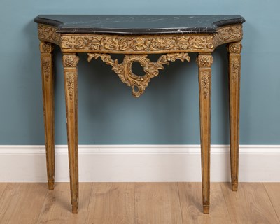 Lot 411 - An 18th century French style ornately carved and painted giltwood console table