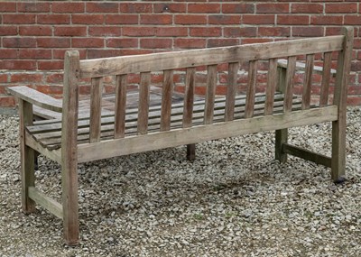 Lot 1127 - An R A Lister teak garden bench