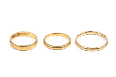 Lot 258 - Two 22ct gold wedding bands, and an 18ct gold...