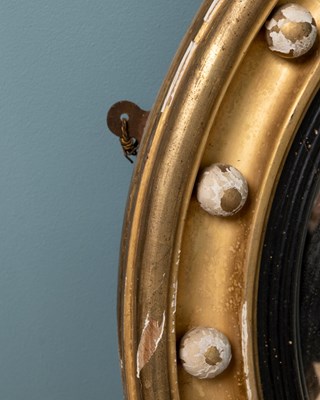 Lot 531 - A regency circular gilt framed convex wall mirror